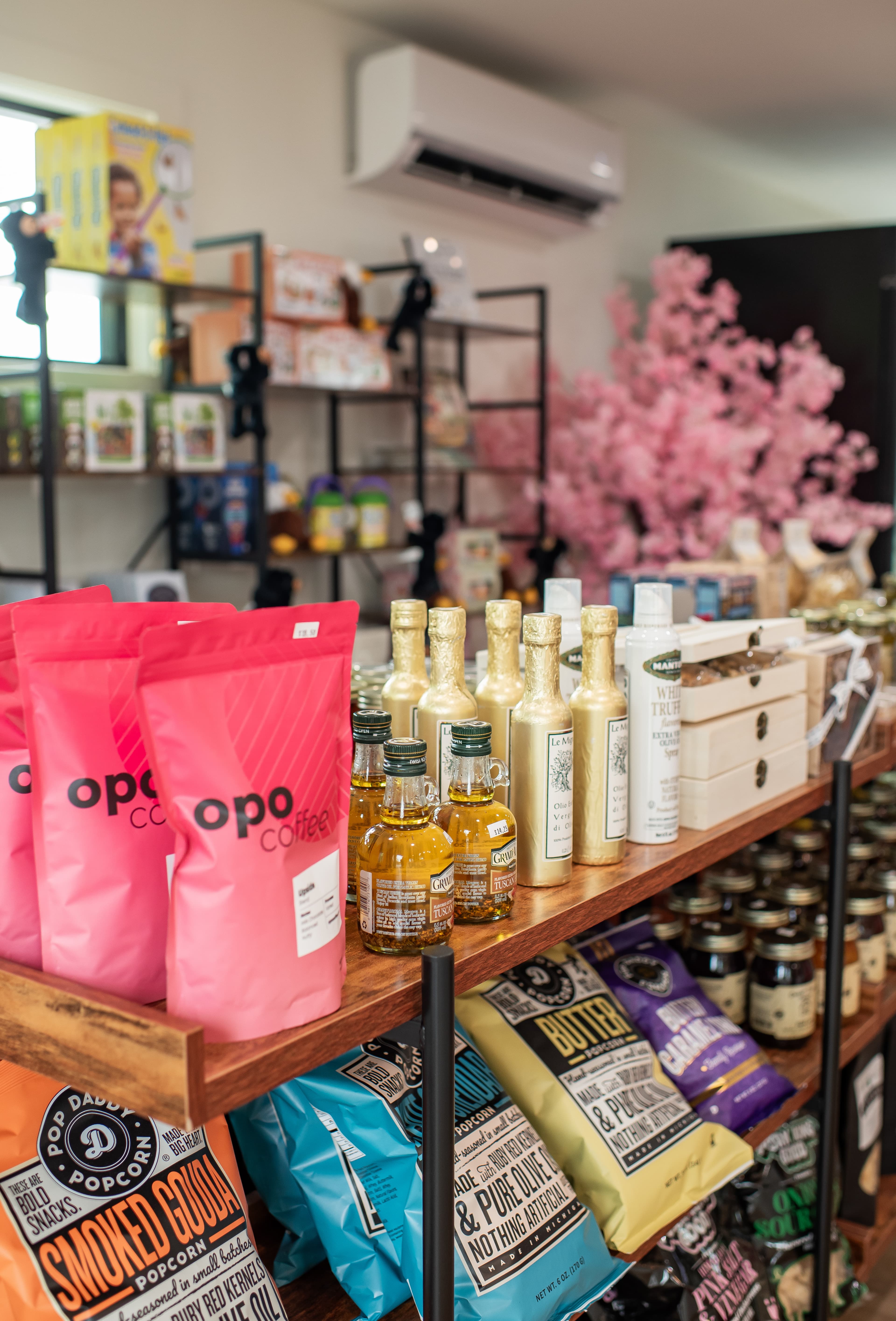 Gift shop shelves at Amelia's Cafe — Opo coffee, artisan goods, local gifts