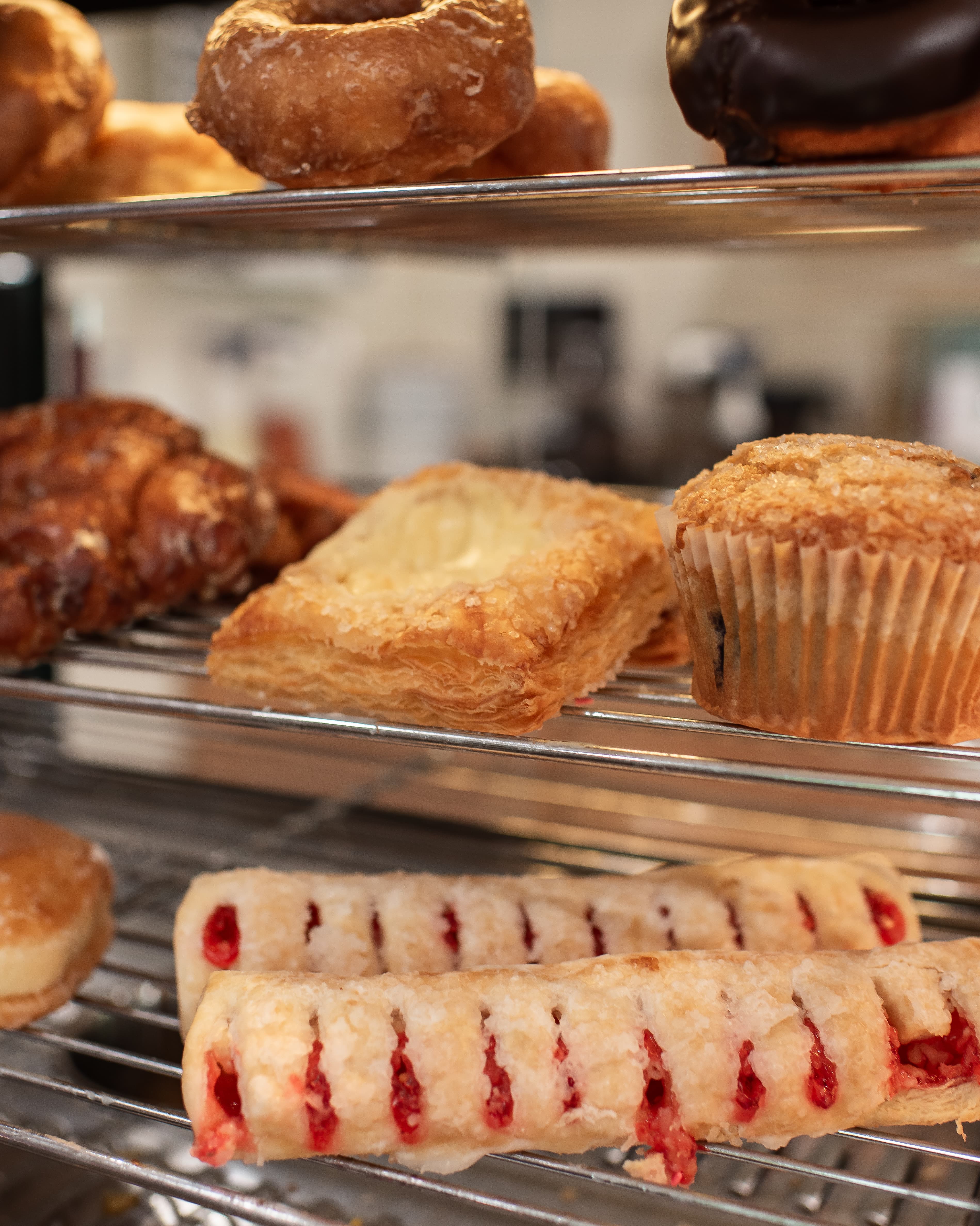 Fresh pastry case at Amelia's Cafe — muffins, turnovers, donuts